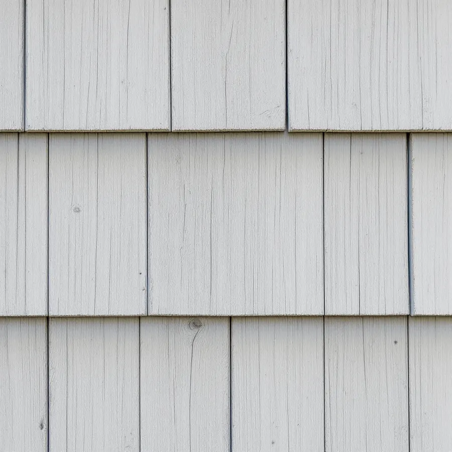 Weathered silver-gray cedar shingles with fine cracks along the grain