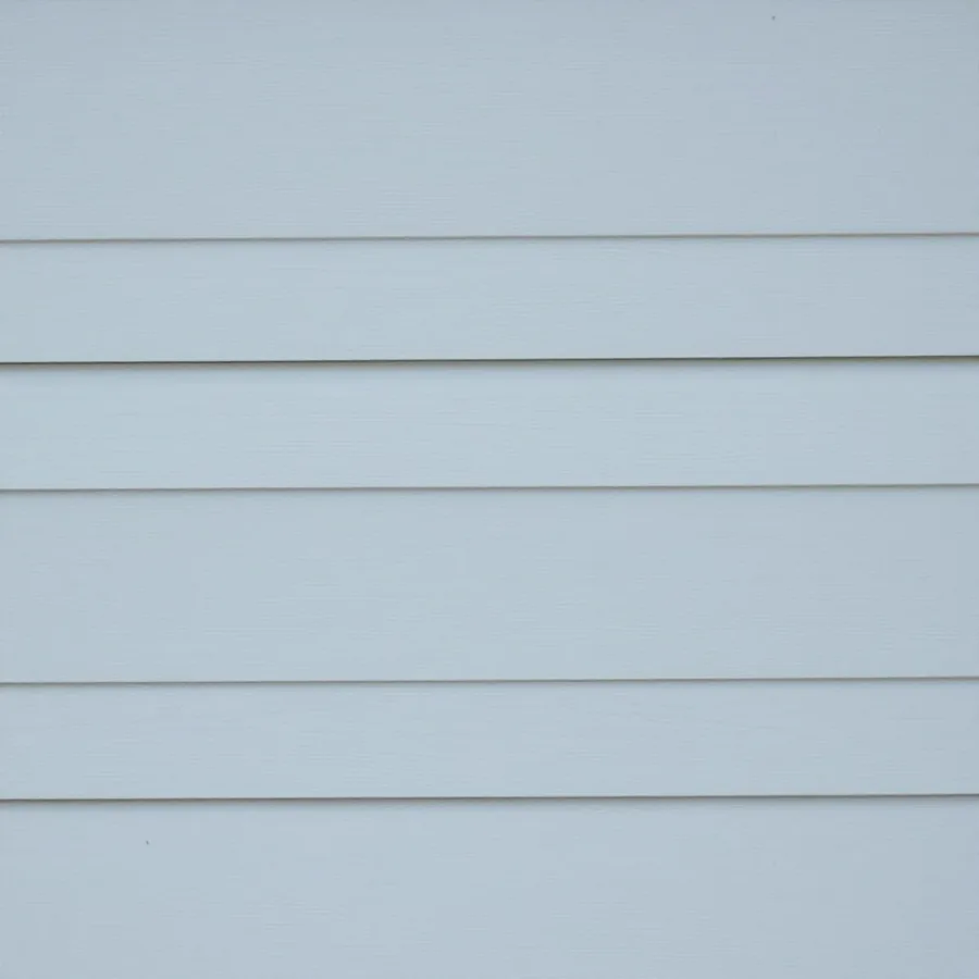 Smooth lap siding boards painted pale blue-gray