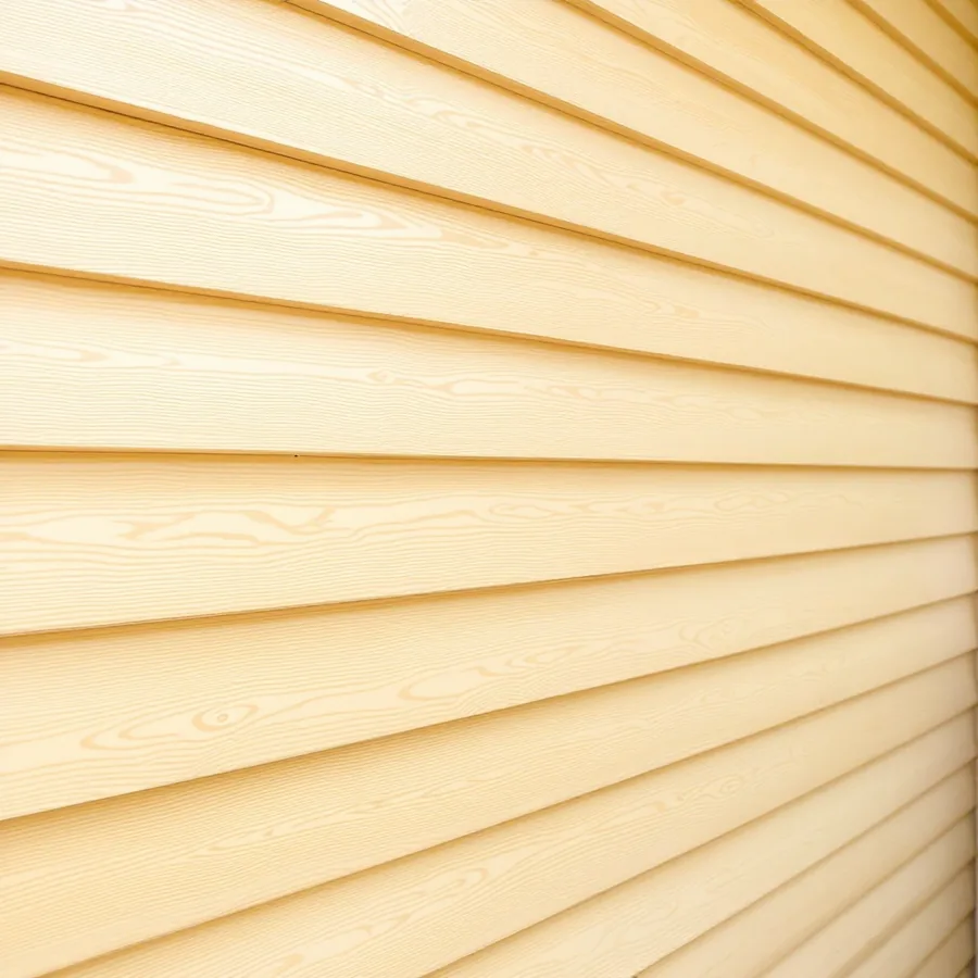 Wall of pale honey colored cypress lap siding with a clear finish and visible grain